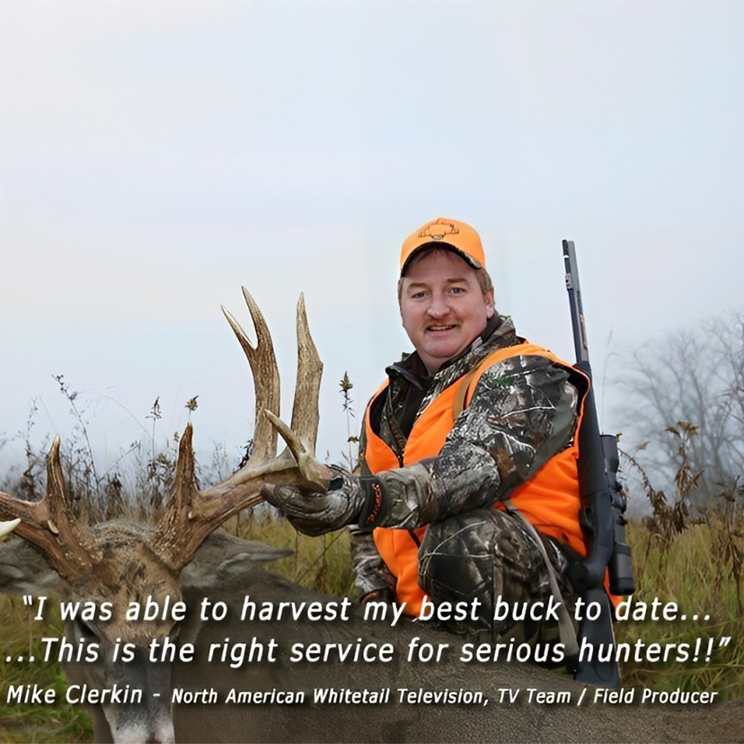A man in an orange vest holds a deer